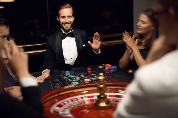 A confident dealer surrounded by casino chips inviting players to access their JETA9 account, reflecting quick and easy login options.